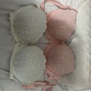 One pink and one white Victoria secret bra